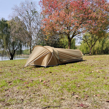 A person emerging from the single person backpacking bivy tent, demonstrating scale.