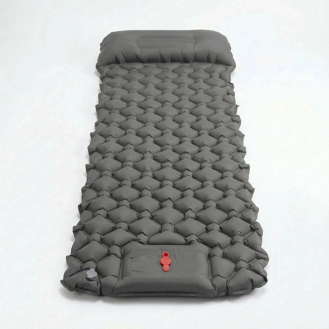 Close-up of the integrated foot pump inflating a portable ultralight camping sleeping pad for quick setup.