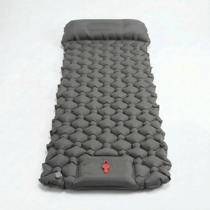 Close-up of the integrated foot pump inflating a portable ultralight camping sleeping pad for quick setup.