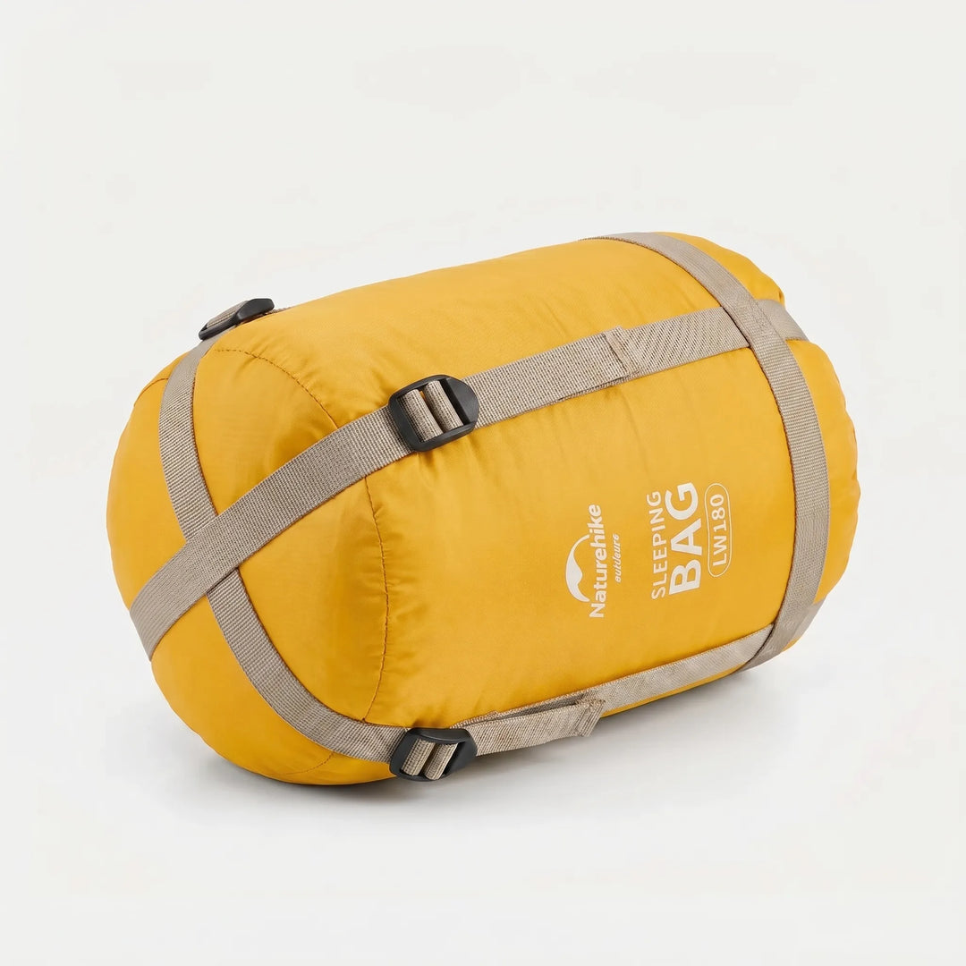 Ultralight compact summer sleeping bag packed in its small stuff sack, essential for backpacking & outdoor travel.