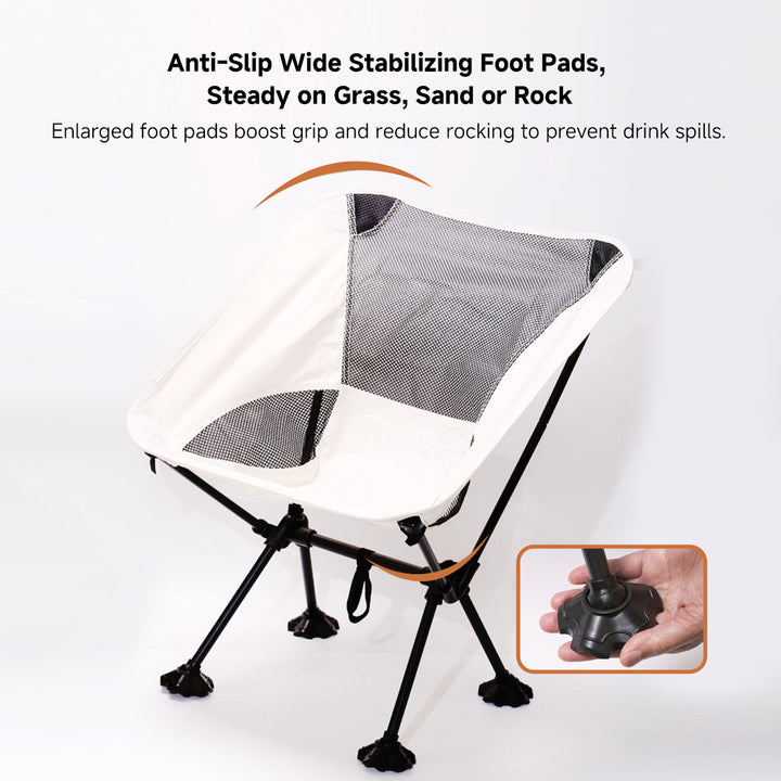 Unisex folding camping chair set up in a scenic outdoor hiking spot, ready for use