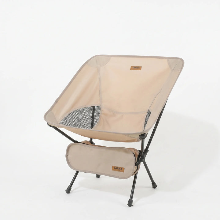 Compact ultralight folding camping chair packed in its carrying bag, ready for travel & outdoor adventures.