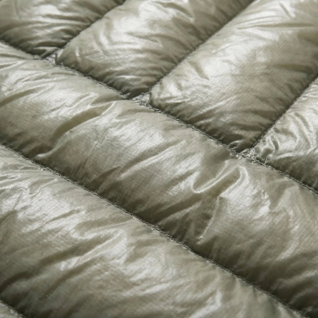 Packable unisex ultralight down mummy bag, ideal compact outdoor gear for travel & camping.