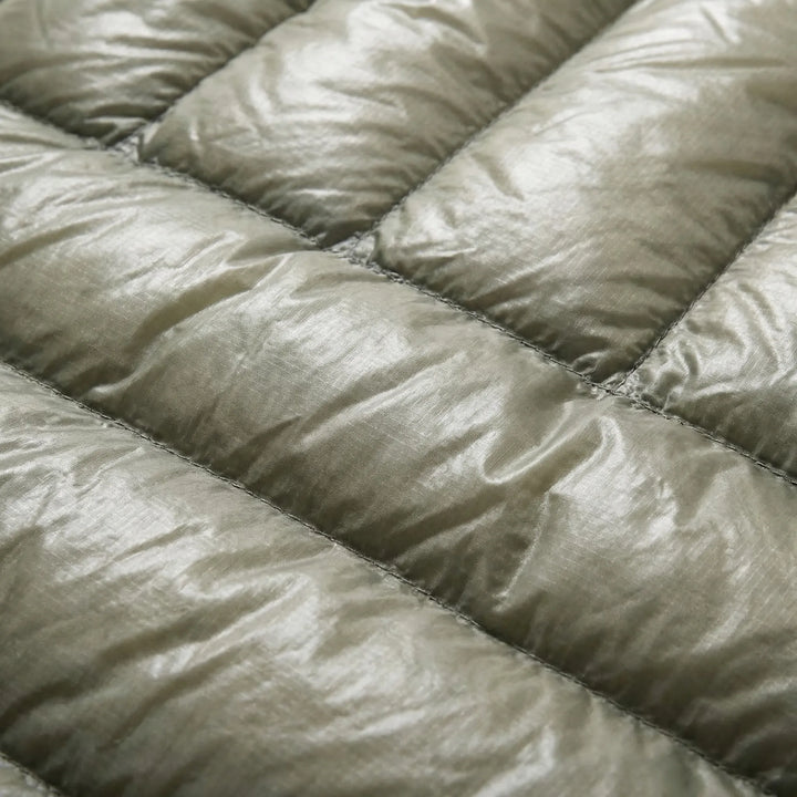Packable unisex ultralight down mummy bag, ideal compact outdoor gear for travel & camping.