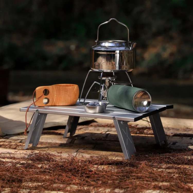 Unisex ultralight portable folding camping table in outdoor setting for picnic or travel