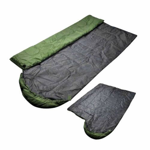 Portable camping sleeping bag unfolded on ground, ready for comfortable outdoor sleep