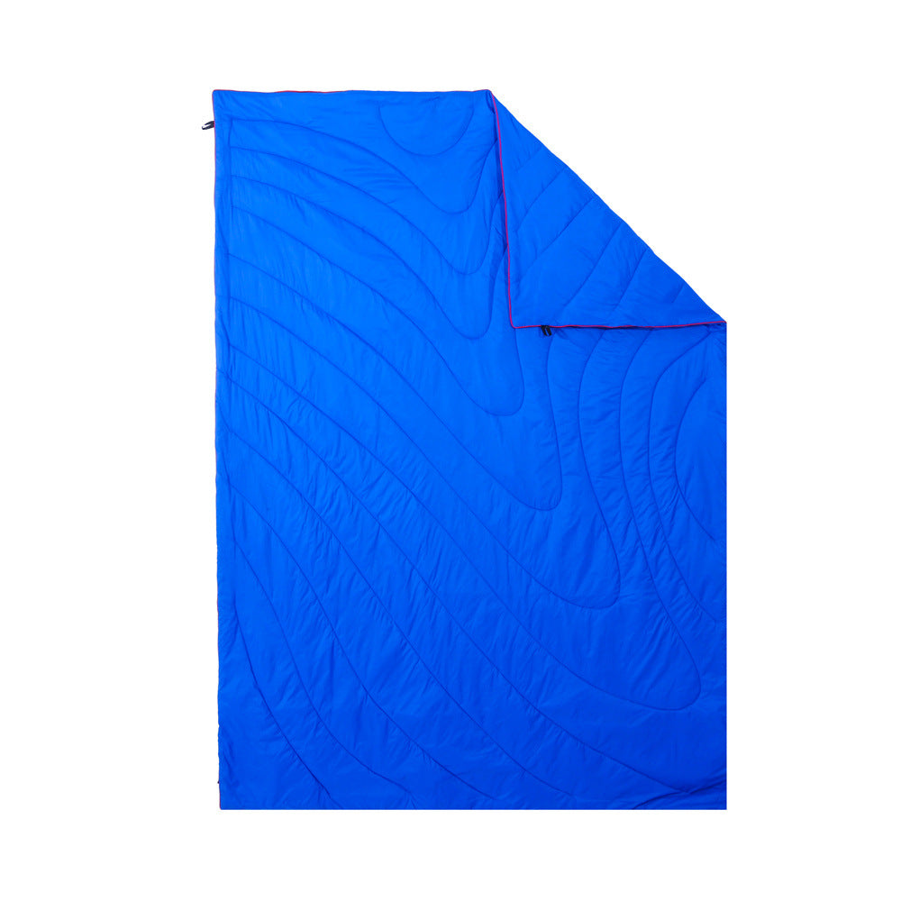 Lightweight wearable blanket being packed into its small carry bag.
