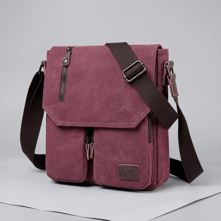 Vintage canvas crossbody bag showing multiple pockets for organized daily essentials & travel.