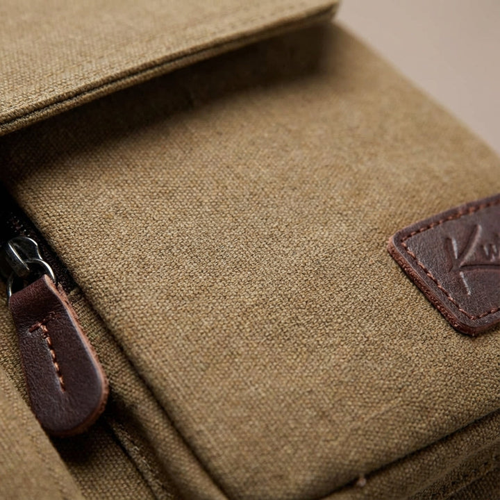Casual unisex vintage canvas shoulder bag worn for daily travel, offering comfortable crossbody wear.