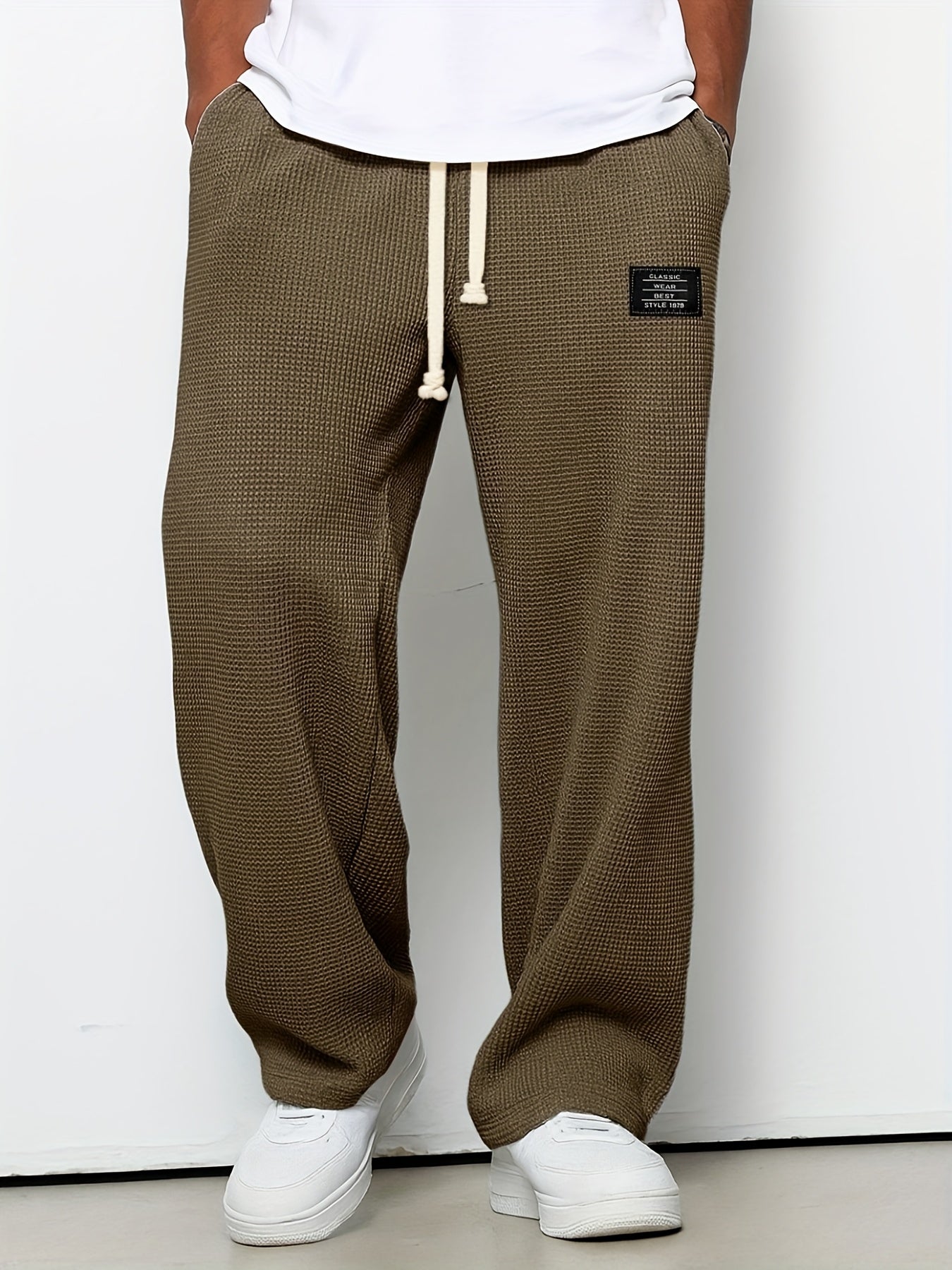 Unisex waffle knit lounge pants in a relaxed fit. Soft comfort wear with a drawstring for casual relaxation.