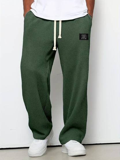 Unisex relaxed fit waffle knit lounge pants. Soft, casual wide-leg comfort pants with a drawstring.