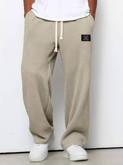 Drawstring waffle knit lounge pants, unisex design with a relaxed, soft wide leg. Ideal for comfort wear.