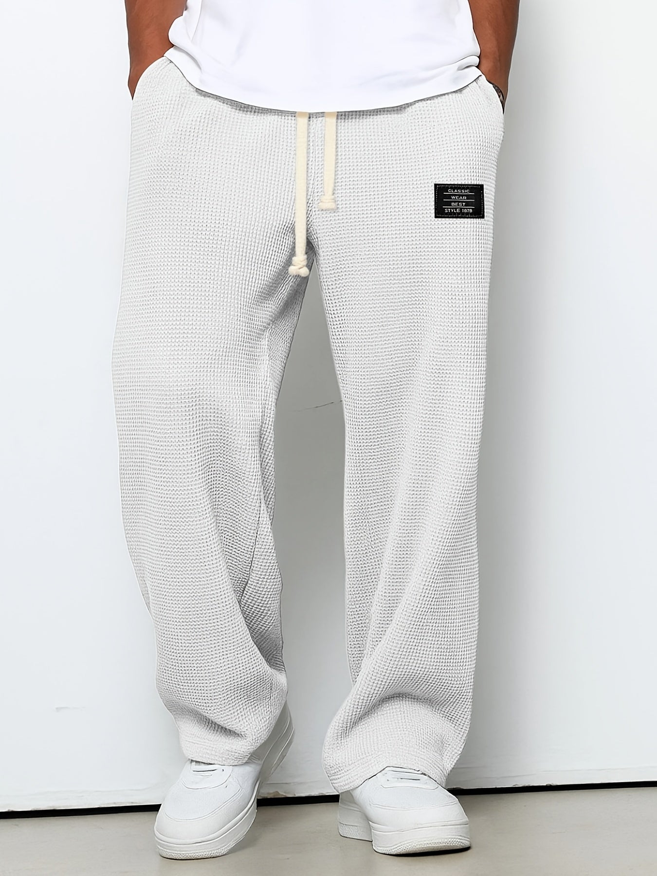 Soft waffle knit relaxed lounge pants for unisex comfort. Casual, wide-leg design with an adjustable drawstring.