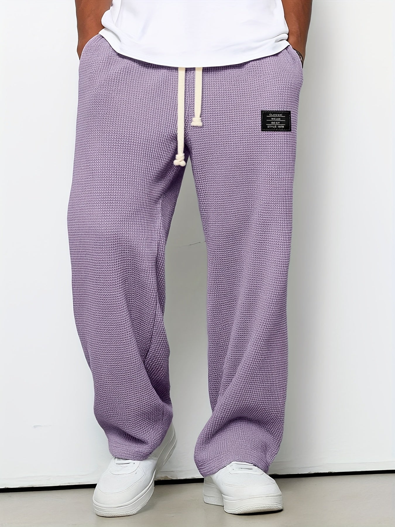 Waffle knit unisex lounge pants, relaxed fit with a drawstring. Soft, wide-leg comfort wear for casual style.