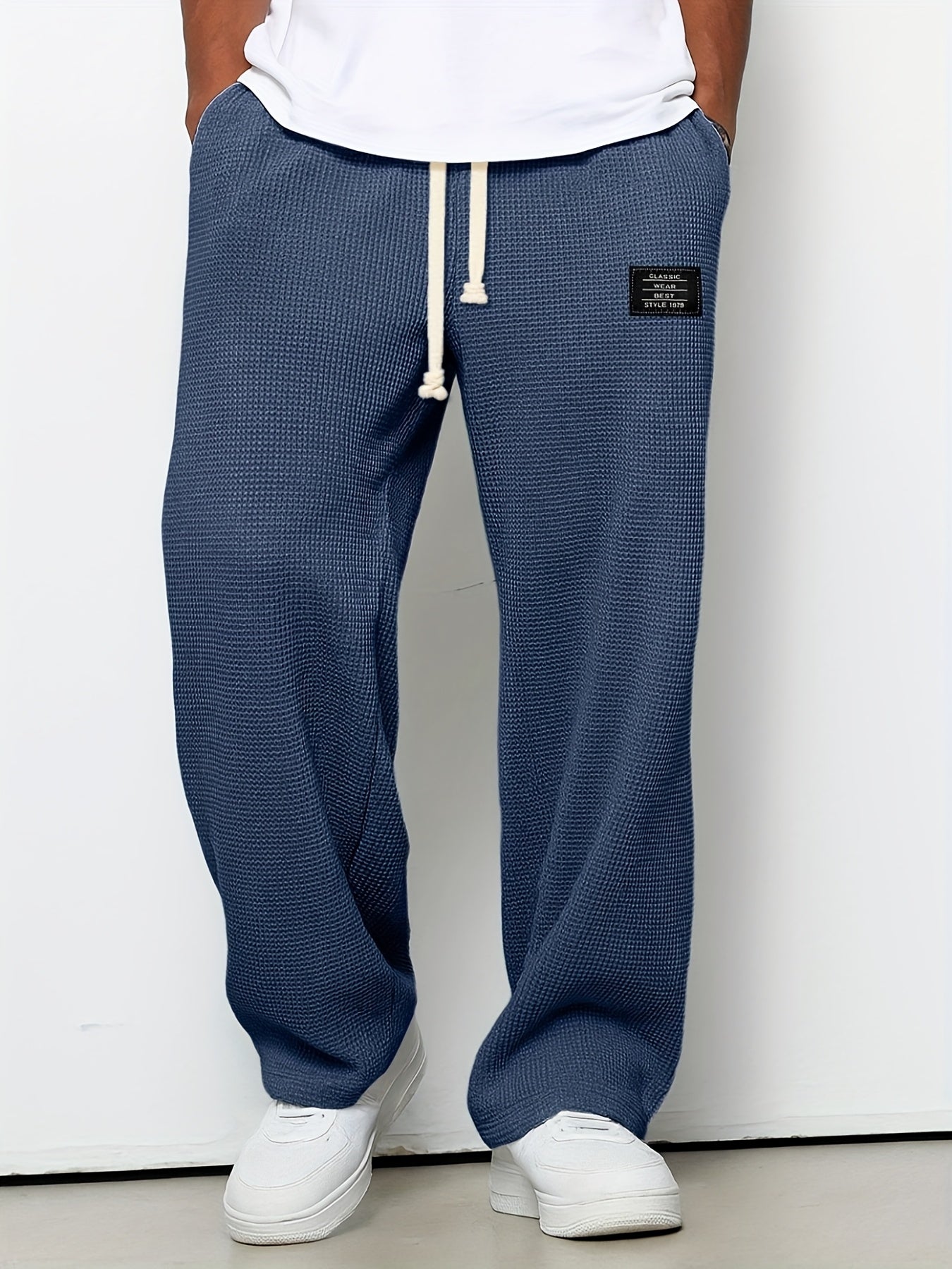 Soft waffle knit relaxed fit lounge pants. Unisex design, wide leg, and drawstring for casual comfort wear.