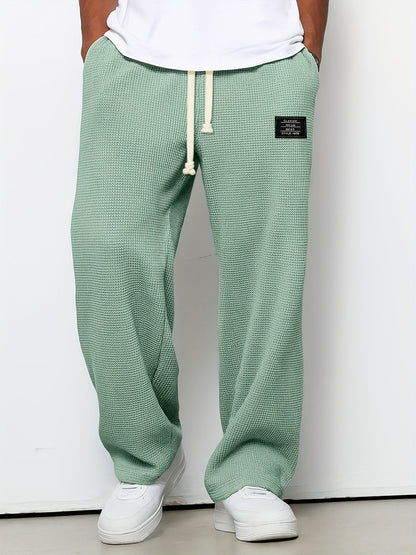 Unisex waffle knit relaxed lounge pants. Soft, textured comfort wear with a wide leg and adjustable drawstring.