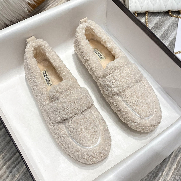 Comfortable unisex home slippers, keeping feet warm and cozy indoors during the winter.