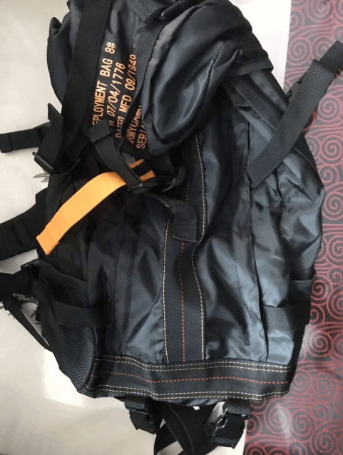 Tactical backpack with large capacity, featuring MOLLE webbing & multiple pockets for organized camping gear.