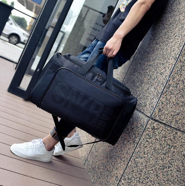 Dedicated sneaker compartment in a sleek, water-resistant unisex travel & gear duffel bag design.