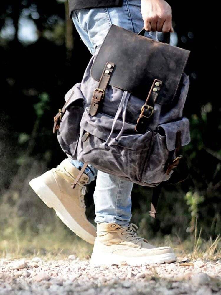 Waterproof canvas and genuine leather travel backpack for hiking, featuring a spacious main compartment