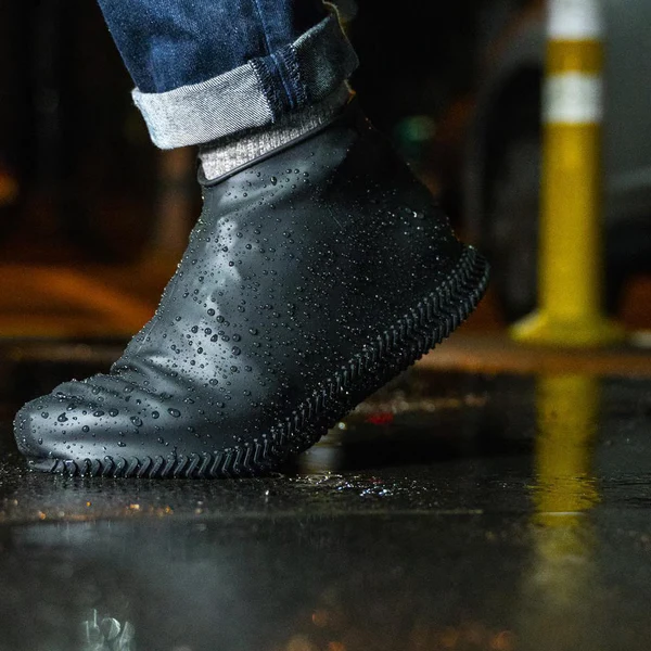 Close-up of durable, reusable waterproof shoe covers with non-slip sole texture for secure outdoor travel.
