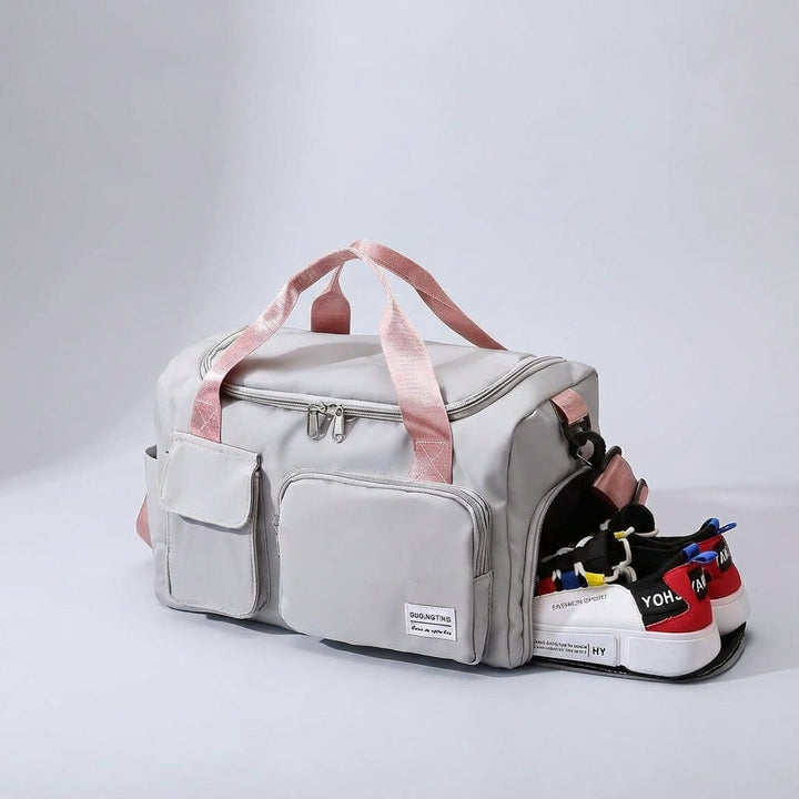 Spacious waterproof nylon travel duffel with multiple compartments for organized gym & weekend essentials. Unisex design.