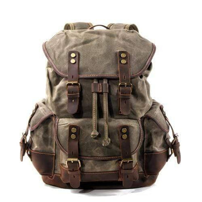 A collection of outdoor gear featuring the waterproof waxed canvas backpack, ready for an expedition