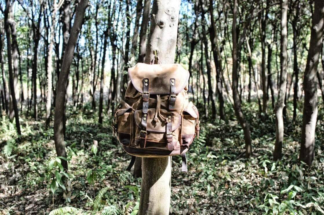 Front view of a versatile unisex waxed canvas rucksack, suitable for daily use or hiking trips