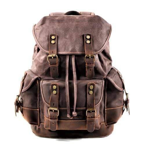 Model wearing the waxed canvas hiking backpack, demonstrating its practical size & stylish outdoor look