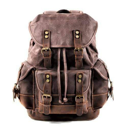 Model wearing the waxed canvas hiking backpack, demonstrating its practical size & stylish outdoor look