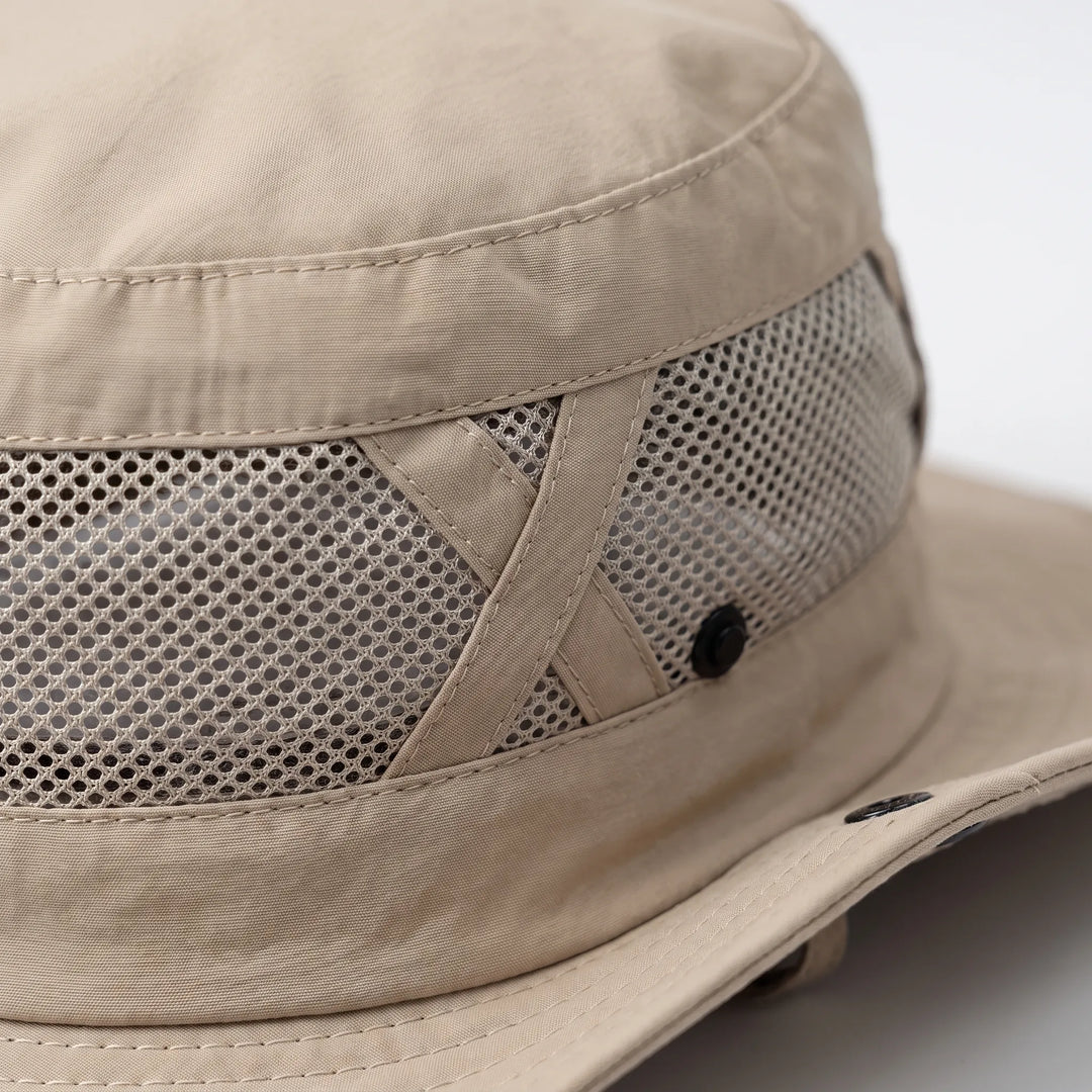 Fishing hat with wide brim & neck flap for ultimate sun protection. Ventilated, quick-dry adventure gear.