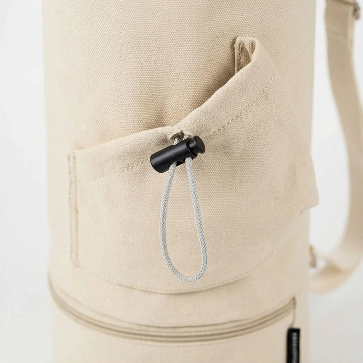 Convenient yoga mat carrier with extra pockets for essentials. Adjustable strap for comfortable, hands-free transport.