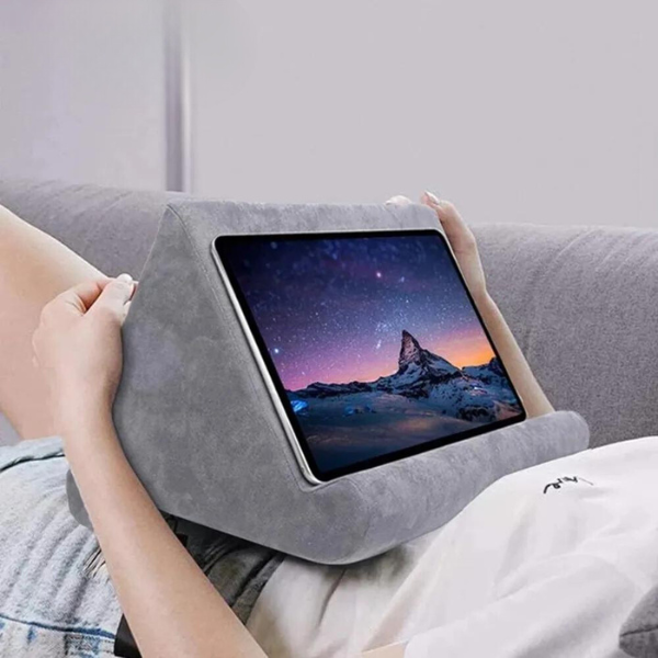 Universal tablet pillow stand for hands-free viewing, soft suede, ergonomic design.