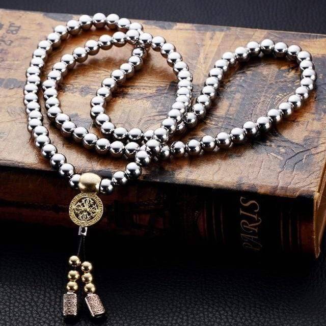 Adventure-ready Buddha Beads Chain, displayed on a rock with a mountainous background.