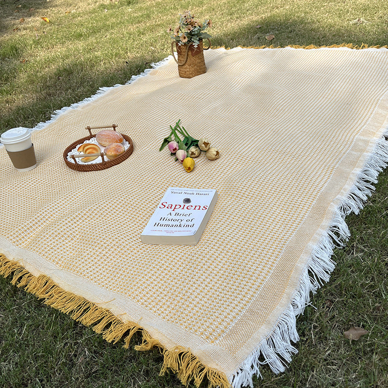 Boho chic checkered outdoor blanket, suitable for camping, picnics, and stylish decor