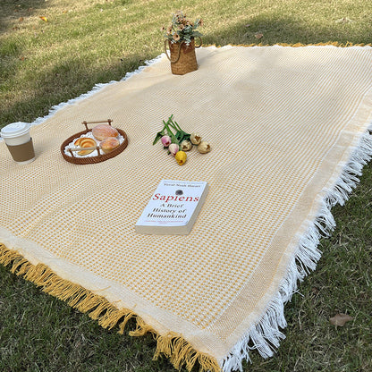 Boho chic checkered outdoor blanket, suitable for camping, picnics, and stylish decor