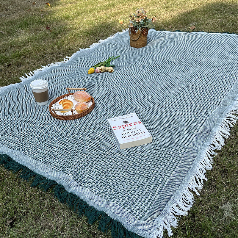 Checkered picnic blanket, moisture resistant and durable, essential for outdoor fun