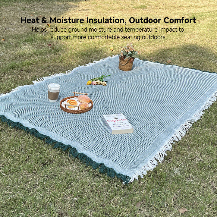 Versatile plaid outdoor blanket, moisture resistant, ideal for picnics & travel
