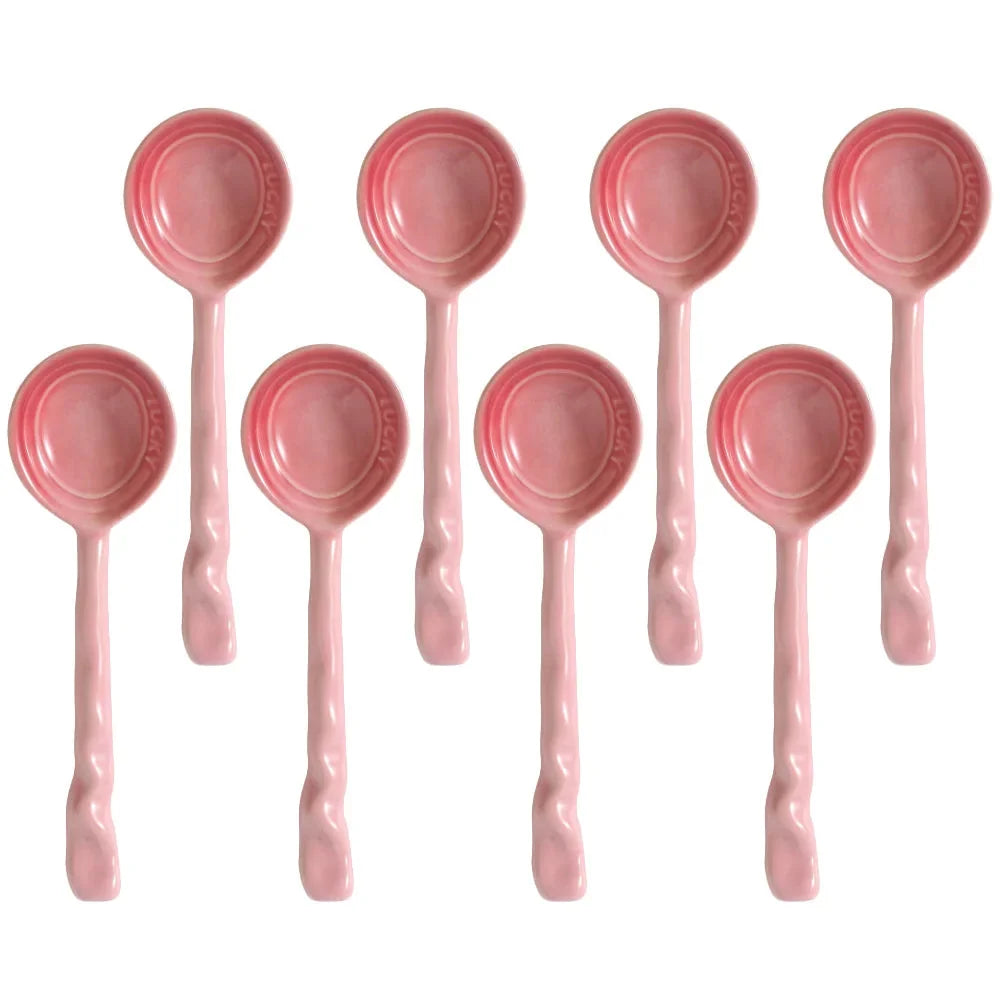 Assortment of colorful ceramic serving spoons, 8-piece kitchen set, great for tableware.