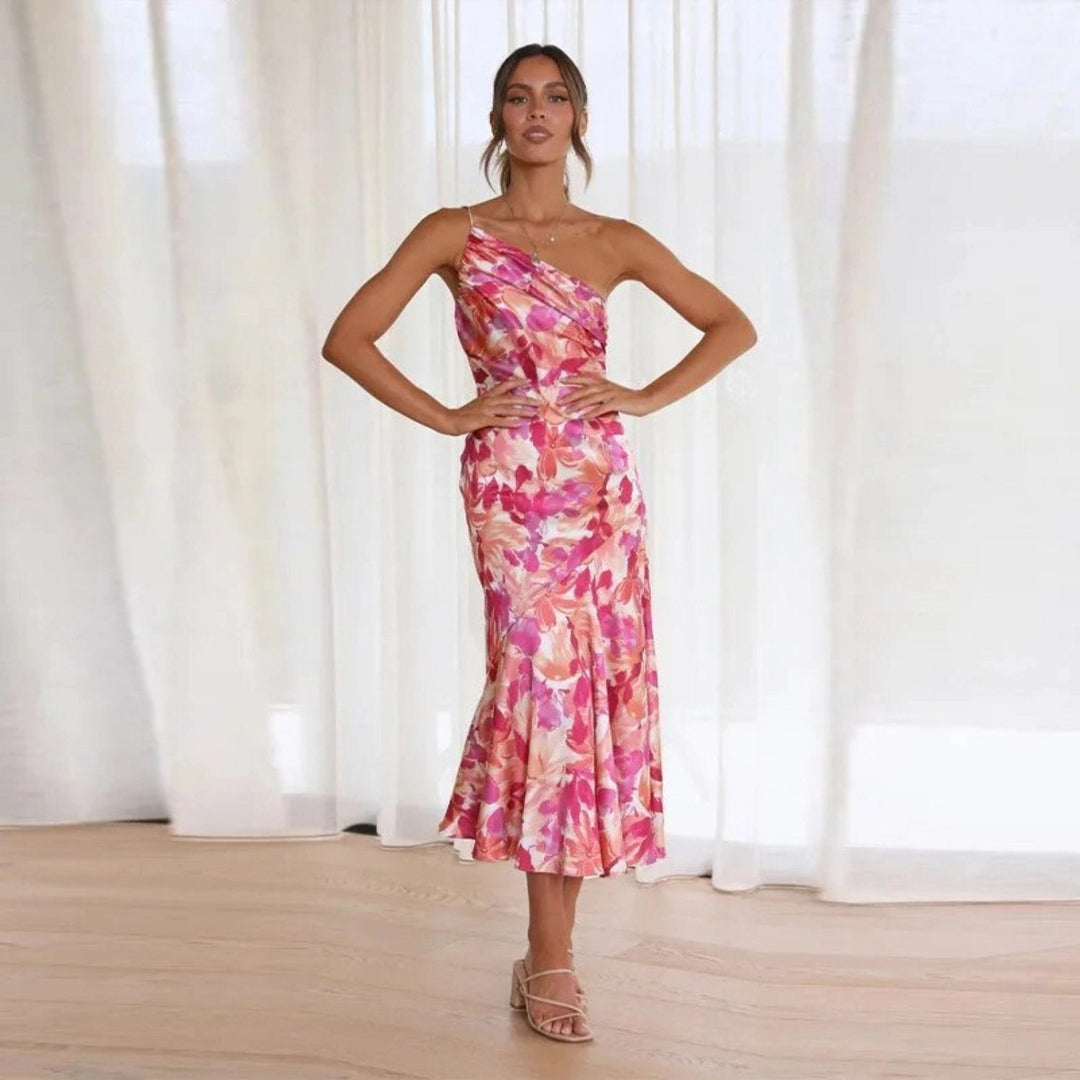 Women's sleeveless floral midi dress with an artistic asymmetric cut and graceful flowing hem for modern style.