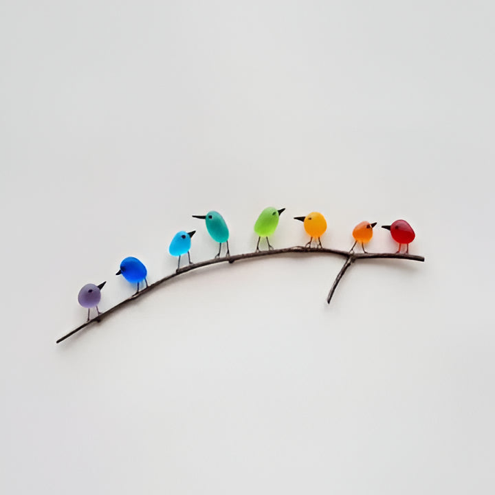 Vibrant sea glass bird art for coastal home decor, featuring a unique rainbow design on driftwood.