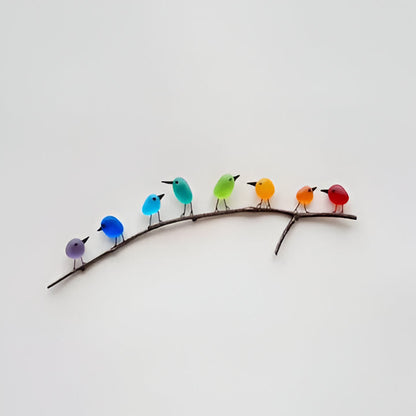 Vibrant sea glass bird art for coastal home decor, featuring a unique rainbow design on driftwood.