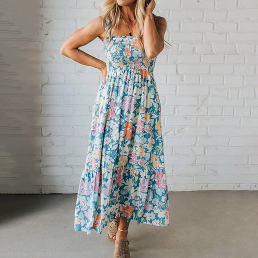 Vibrant women's smocked floral maxi dress for summer. Sleeveless casual style with ruffled hem, perfect for vacation.