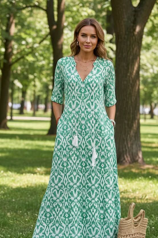 Woman enjoying summer in a vibrant, flowy maxi dress. Perfect comfortable & stylish beachwear or resort outfit.