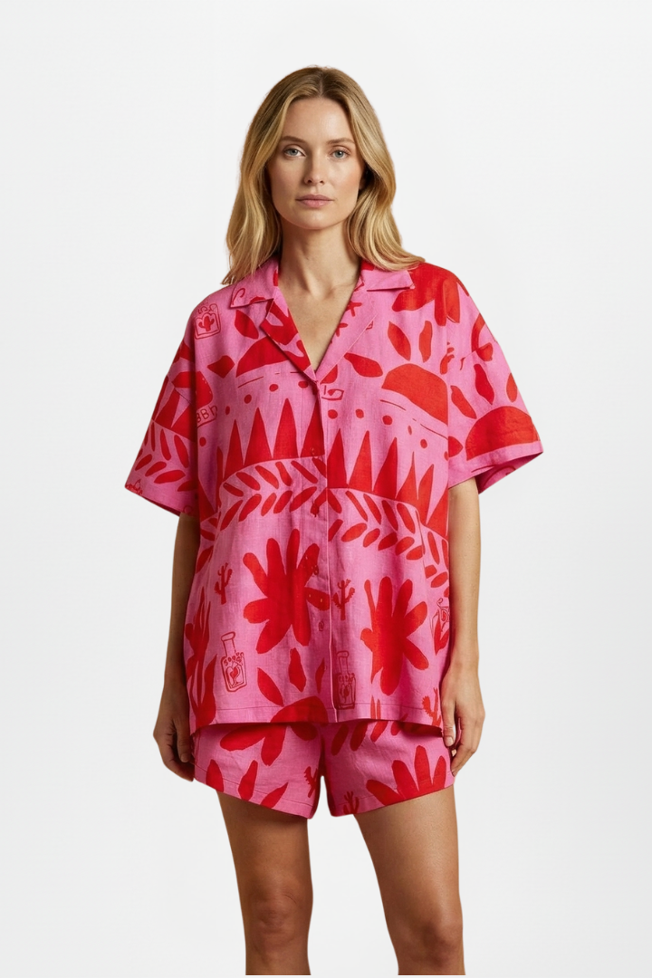 Chic women's tropical print camp collar shirt and shorts set, ideal resort wear & vacation style.