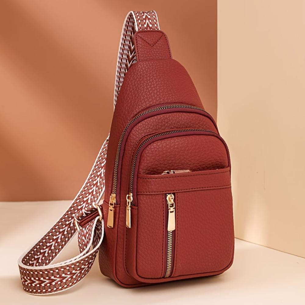 Red vintage leather crossbody, women's essential fashion accessory for versatile styling.