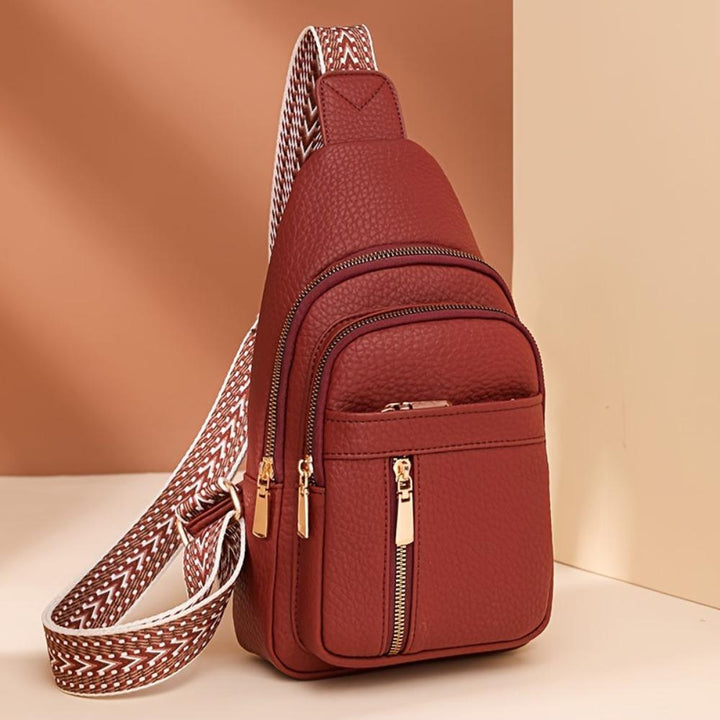 Red vintage leather crossbody, women's essential fashion accessory for versatile styling.