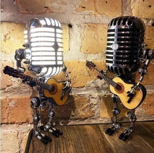 Handcrafted metal robot table lamp with vintage microphone and guitar, a cool piece of music-themed art.