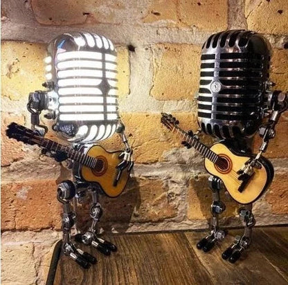 Handcrafted metal robot table lamp with vintage microphone and guitar, a cool piece of music-themed art.