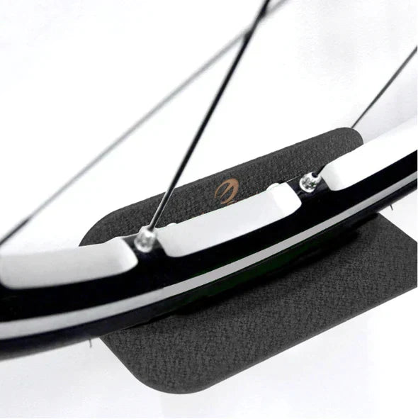 Minimalist bicycle wall hanger, keeping bikes off the floor. Space-saving bike storage solution for a tidy garage or home.